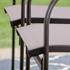 Ensemble repas d'extérieur 7 pièces Captiva Designs avec table rectangulaire à lattes et chaises de salle à manger fixes en textilène