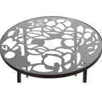 LeisureMod Devon Ensemble de salle à manger d'extérieur 5 pièces - Table ronde en verre avec 4 chaises empilables noires à motif floral