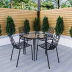 LeisureMod Devon Ensemble de salle à manger d'extérieur 5 pièces - Table ronde en verre avec 4 chaises empilables noires à motif floral