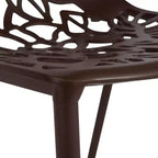 LeisureMod Devon Ensemble de salle à manger d'extérieur 5 pièces - Table ronde en verre avec 4 chaises empilables noires à motif floral